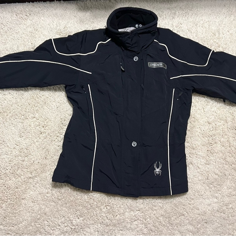 Black Spyder ski jacket with zip out liner that can be worn separately.
